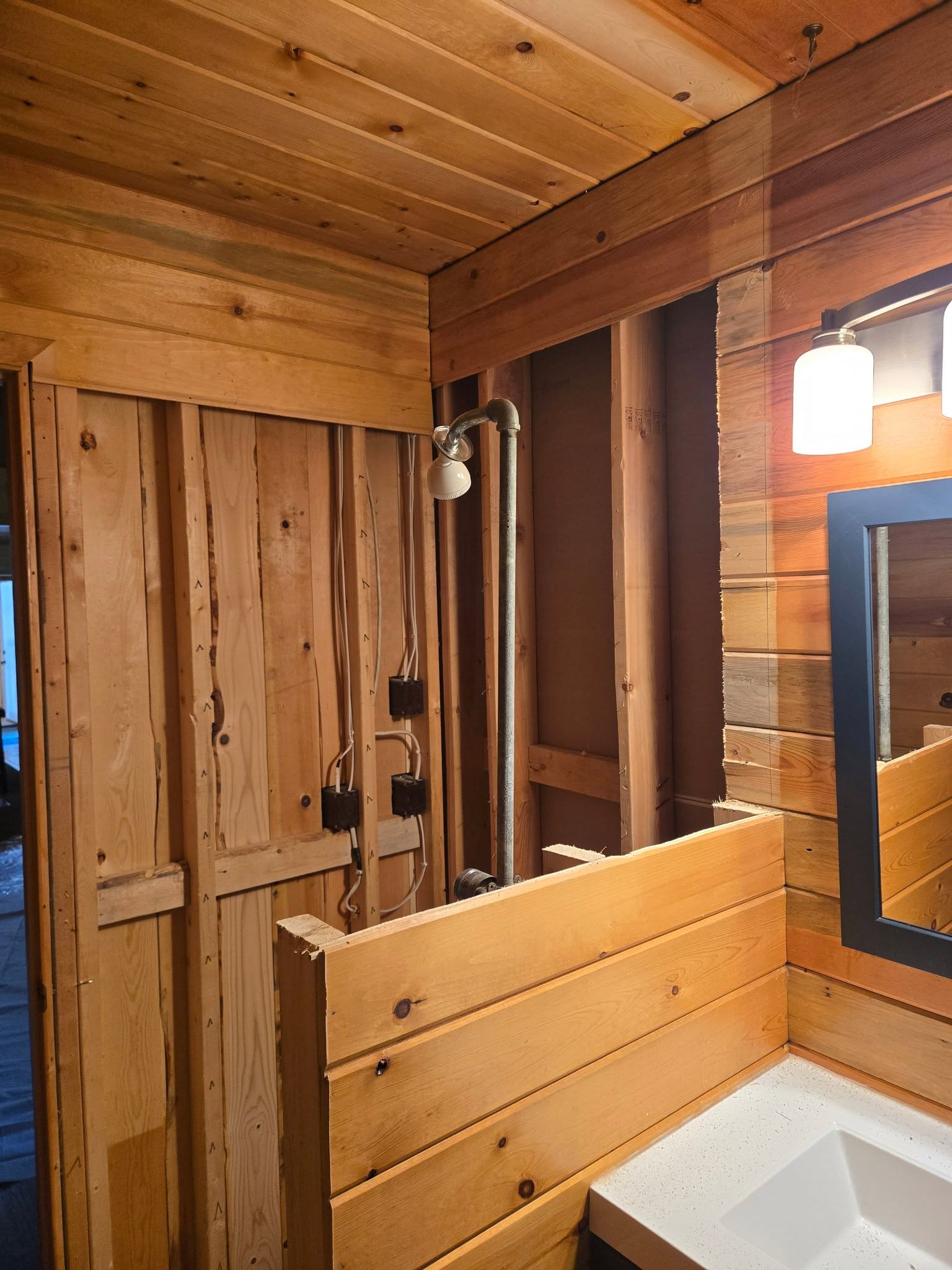 Space before renovation, exposed framing and plumbing